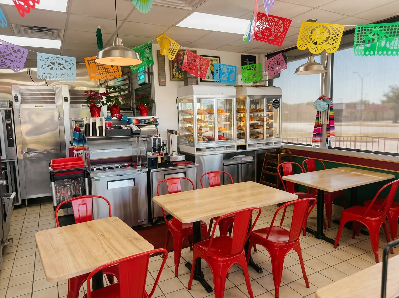 Culebra Café dining room with red chairs and light wood tables